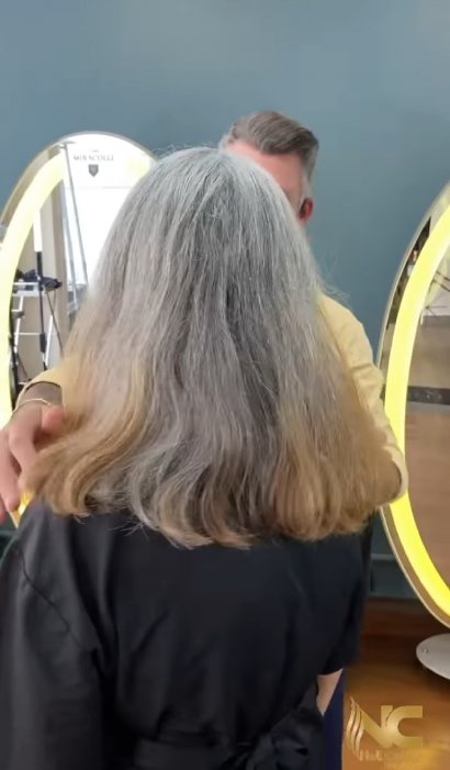Ta kobieta miała długie, siwe włosy, które...