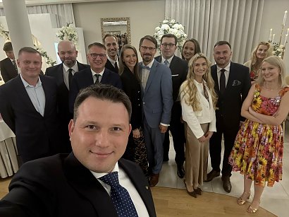 Małżonka Mentzena postawiła na kwiecistą sukienkę i złote sandałki.